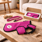 Pink pet accessory set on a wooden table with a living room background